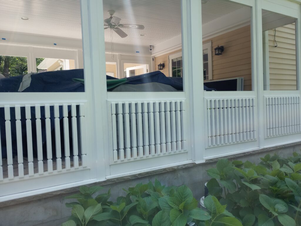 Detailed white exterior trim, wood railings, posts, and decorative woodwork professionally painted in Ramsey, NJ