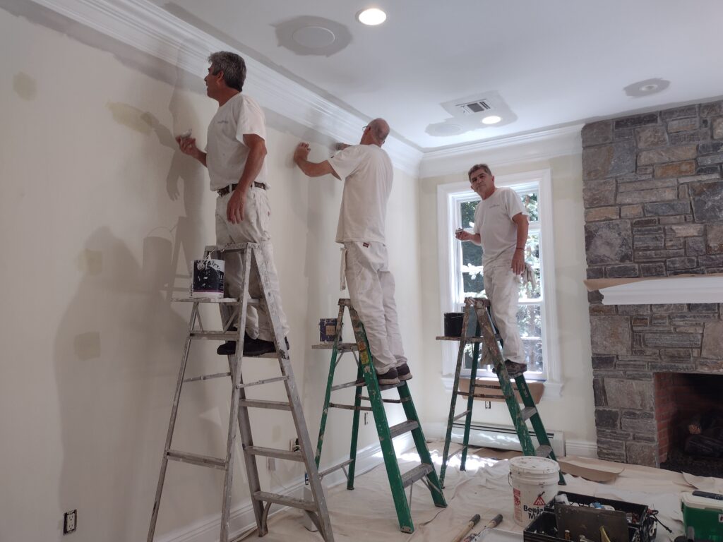 Professional painters completing interior wall and trim painting in a Saddle River, NJ home