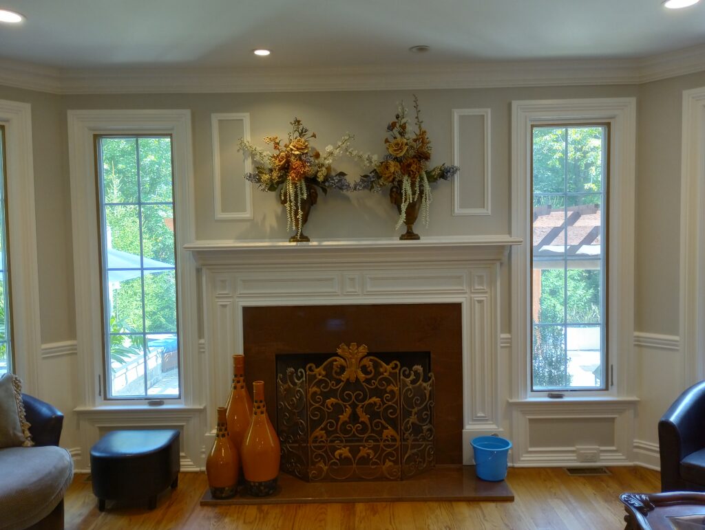 Detailed white interior trim, fireplace surround, crown molding, and window casings painted in Upper Saddle River, NJ